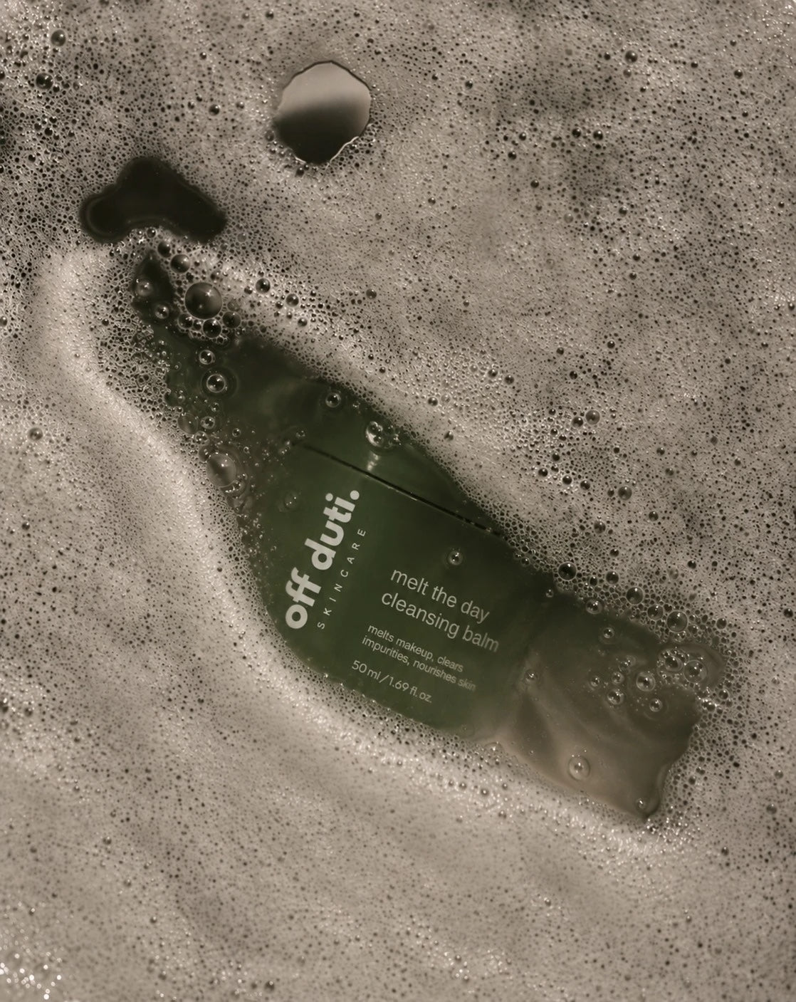 off duti. melt the day cleansing balm under water and soap foam
